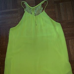 Neon yellow shirt with lace and buttons on back.